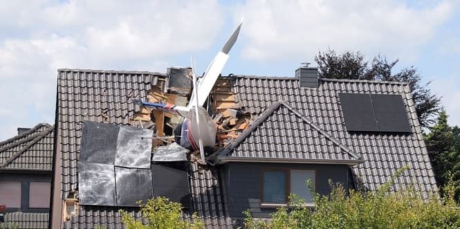 Germany: Private plane crashes onto house roof; two dead.